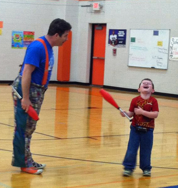 Paul Miller of Circus Mojo with a student at Williamstown Elementary School