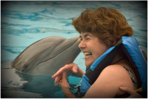 Sandy Desatnik swimming with a dolphin